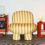 talent design, modern çizgili berjer koltuk, renkli desenli tekli koltuk, minimal tasarım salon koltuğu, yuvarlak hatlı iç mekan koltuğu, çağdaş çizgili döşemeli koltuk, konforlu ve tarz tekli oturum, dekoratif modern koltuk önerisi, genç ve dinamik koltuk stili, şık formda desenli koltuk modeli, renkli iç mekan uyumlu koltuk, kol destekli modern berjer alternatifi, çizgili kumaş döşeme trendi, eğlenceli ve modern çizgi estetiği koltuk